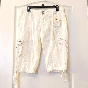 Capri pants with zippered and dome pockets.